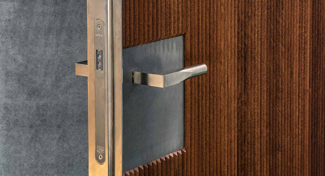 silver lever handle on wooden door