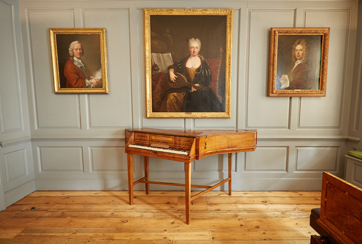 Three Portraits On Panelled Wall Above Piano